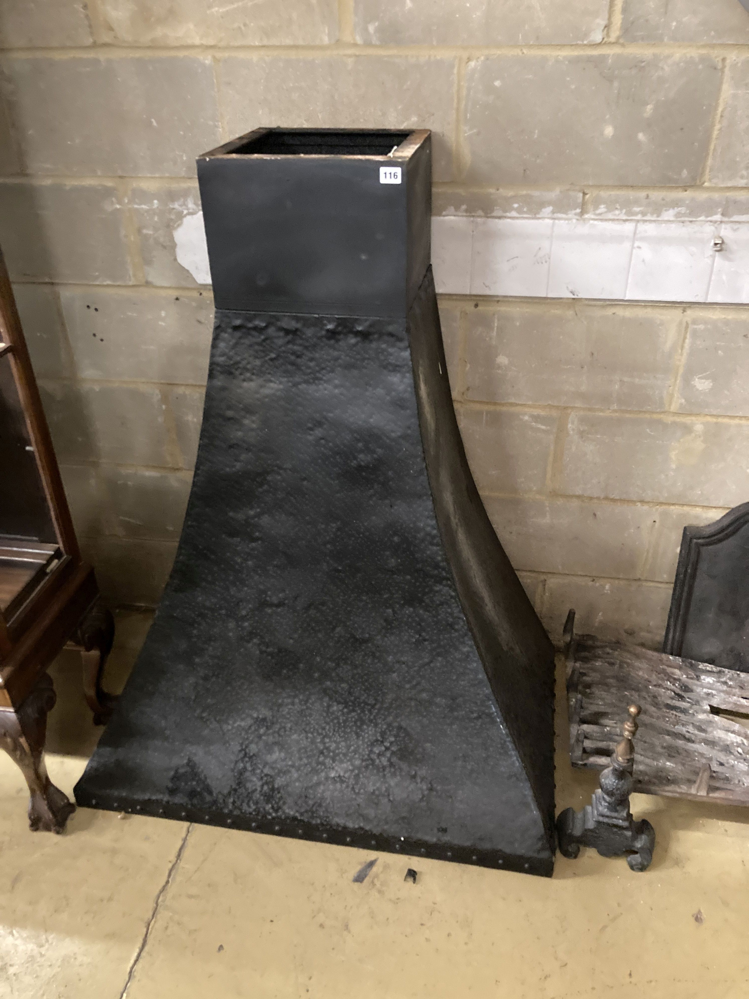 A fireside set comprising of cast iron fire back, basket, width 92cm, height 43cm, pair of dogs and a hammered cowl